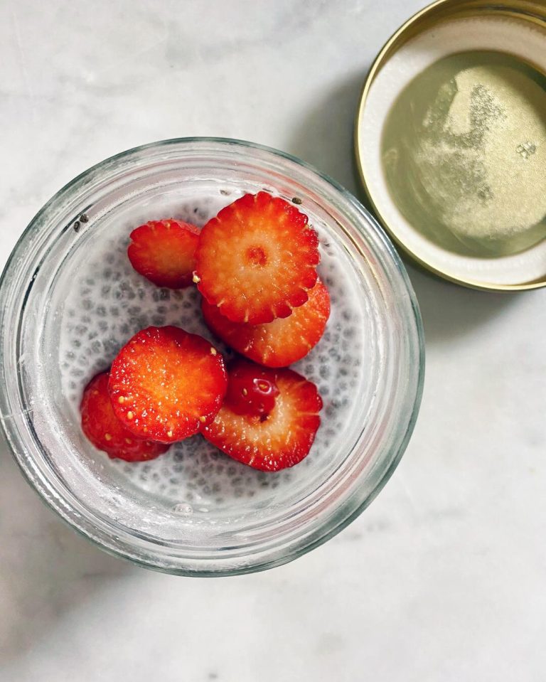 Une verrine de pudding de chia vegan, garnie de tranches de fraises fraiches