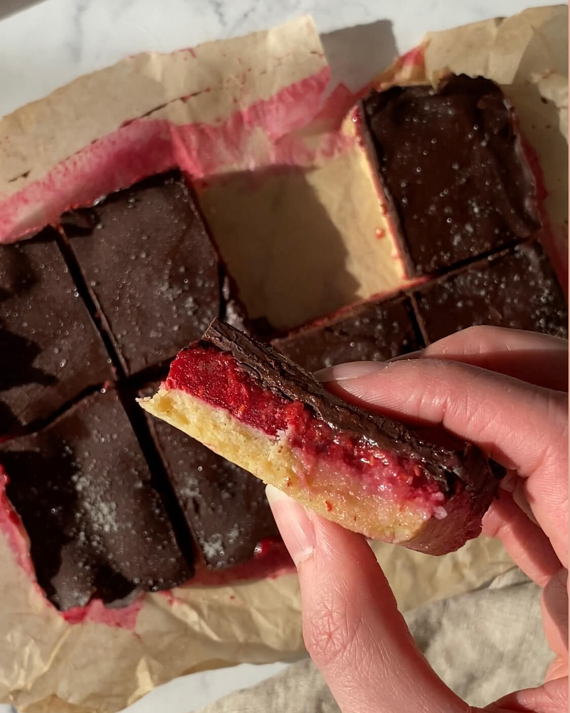 barres crues sans gluten avec un fourrage framboise et recouverte d'une couche de chocolat noir croquant